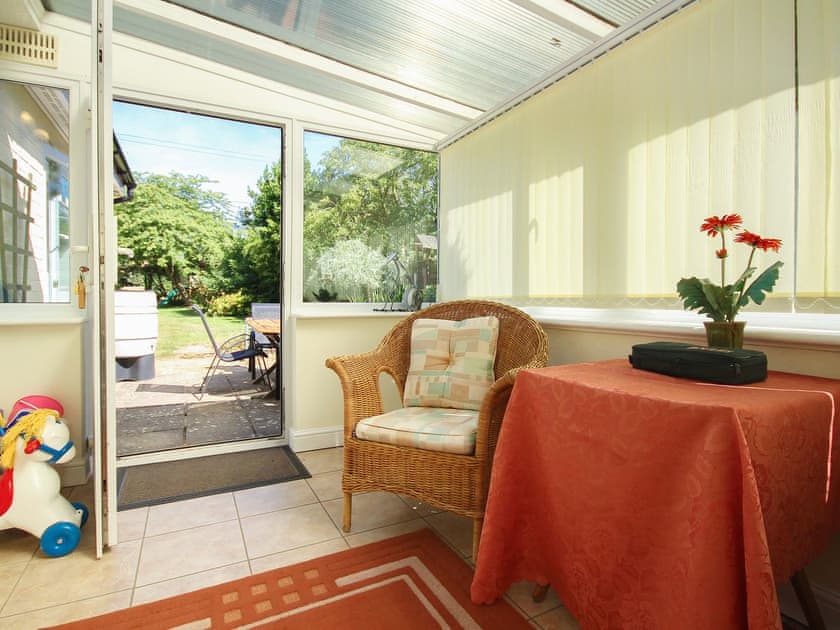 Light and airy conservatory opening up onto the garden | Woodside Cottage, Sandford, near Shanklin