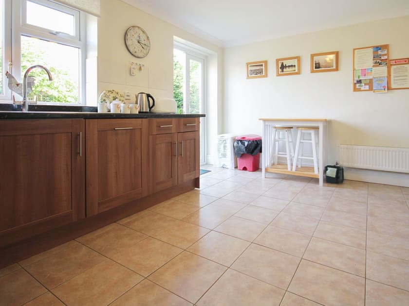 Large well-equipped kitchen with French doors to the garden | Woodside Cottage, Sandford, near Shanklin