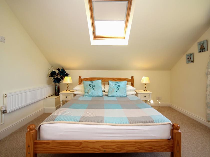 Delightful double bedroom with sloping ceiling and roof light | Woodside Cottage, Sandford, near Shanklin