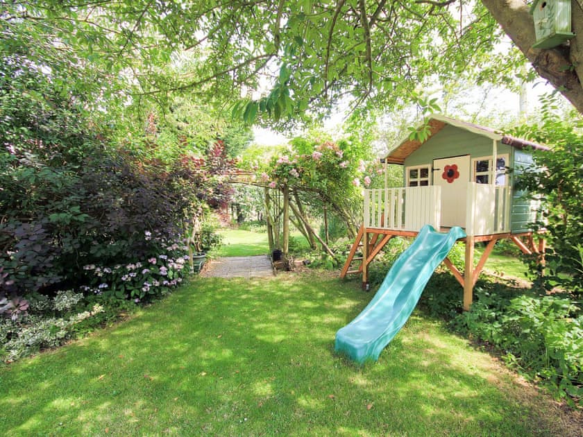 Secluded children’s play area within the garden | Woodside Cottage, Sandford, near Shanklin