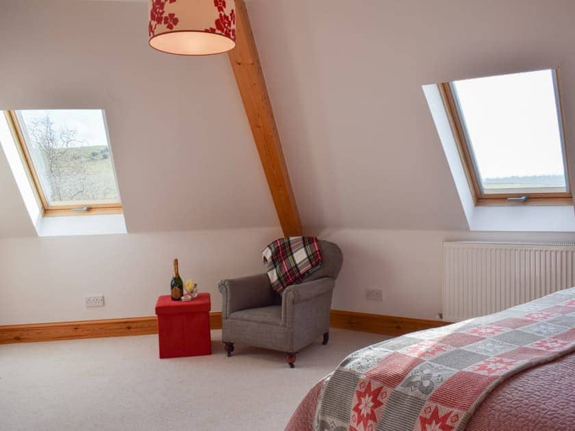 Bedroom with sloping ceiling and exposed woodwork | The Roundel, Balmullo, near St Andrews