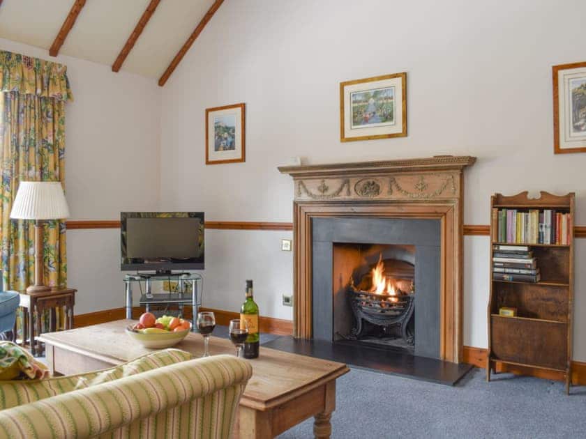 Welcoming living area with a real open fire | Jock Scott Cottage - Kinnaird Estate Cottages, By Dunkeld, Pitlochry