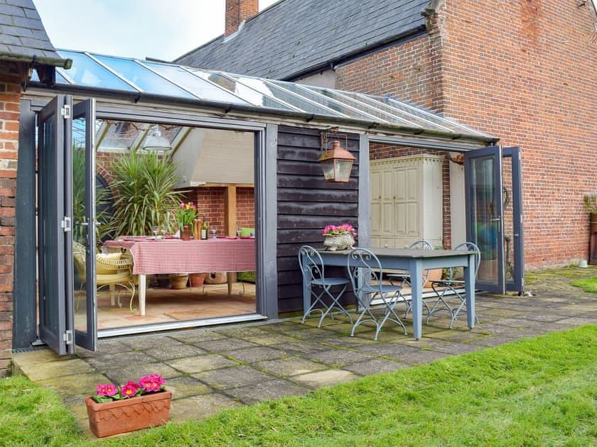 Wonderful conservatory/ dining room leading into the garden | Swallows Nest, Ilketshall St. Margaret, near Bungay