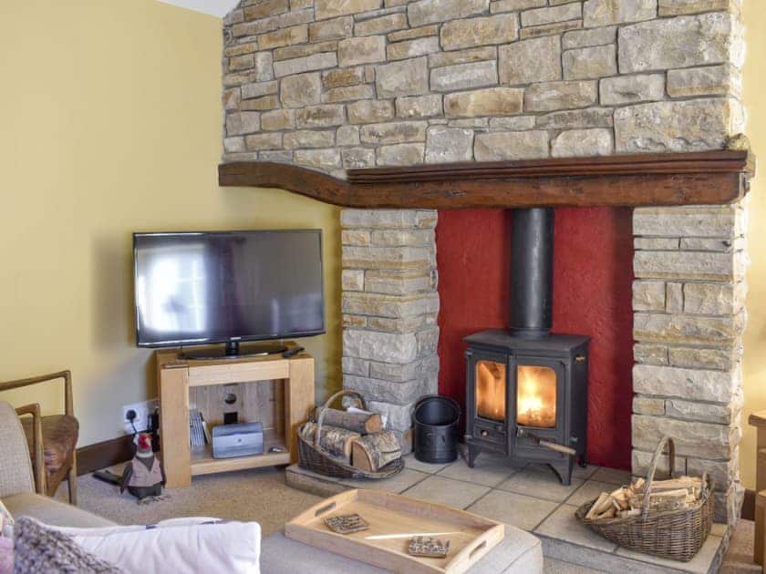 Warming wood burner within the living and dining room | Timbessie Barn, Carperby, near Leyburn