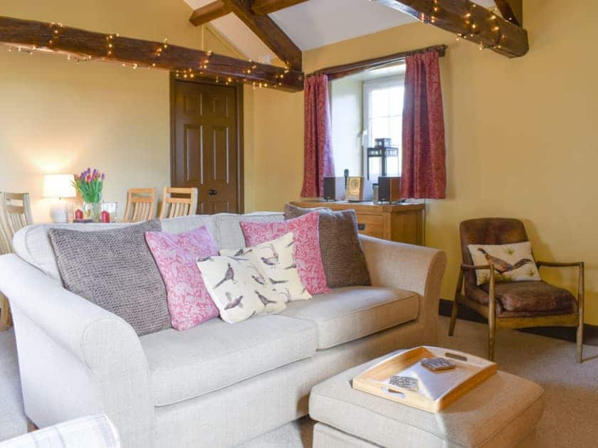 Characterful living and dining room with exposed wooden beams | Timbessie Barn, Carperby, near Leyburn