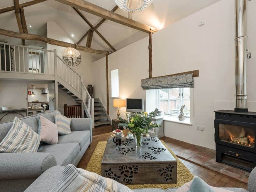Cosy living room with wooden flooring & vaulted ceiling | Heron Barn, Lamas, near Buxton