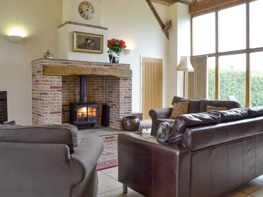 Welcoming living area with wood burner | The Hayloft - Mackinder Farms, Brayton, Selby