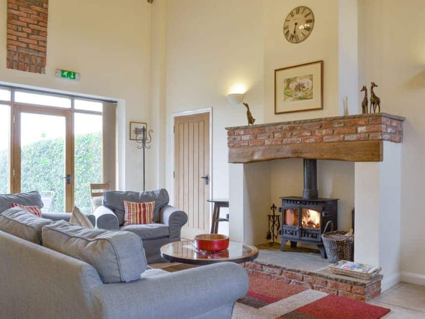 Welcoming living area with wood burner | The Forge - Mackinder Farms, Brayton, Selby