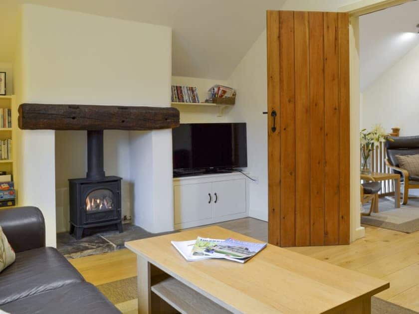 Welcoming living room with wood burner | Tythe Barn, Grindleford