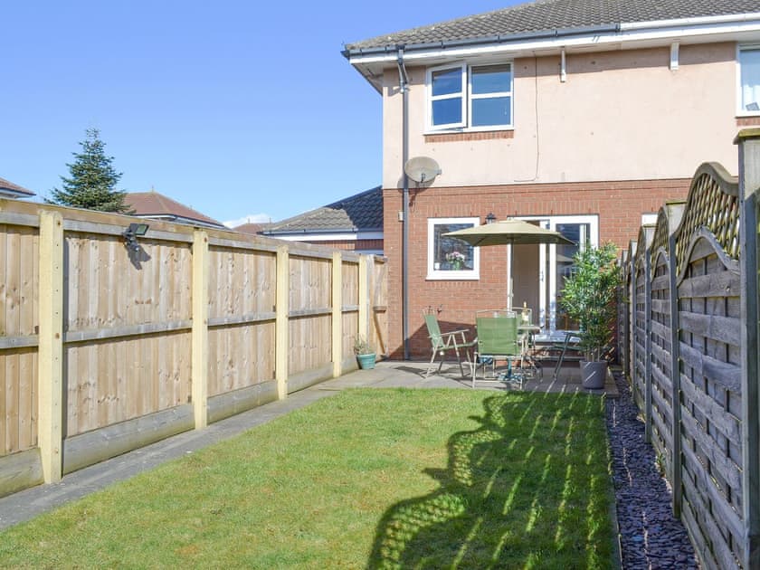 Enclosed lawned garden with outdoor furniture | Signals Court, Scarborough