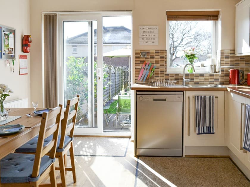 Airy kitchen/diner with patio door to garden | Signals Court, Scarborough