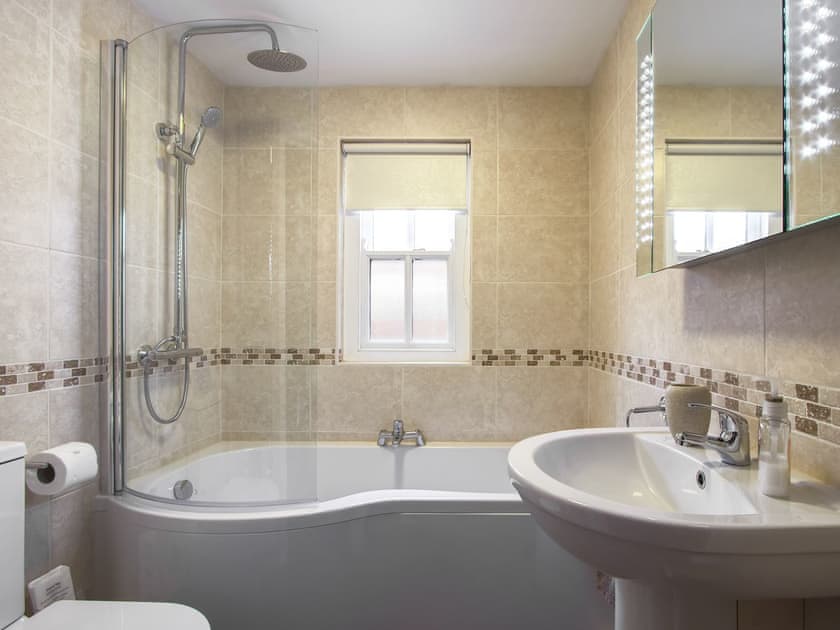 Bathroom with shower over bath | Fferam Gorniog, Holyhead Mountain, near Trearddur Bay