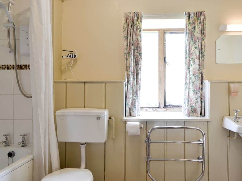 Family bathroom with shower over bath | The Coach House, Kington, near Hereford