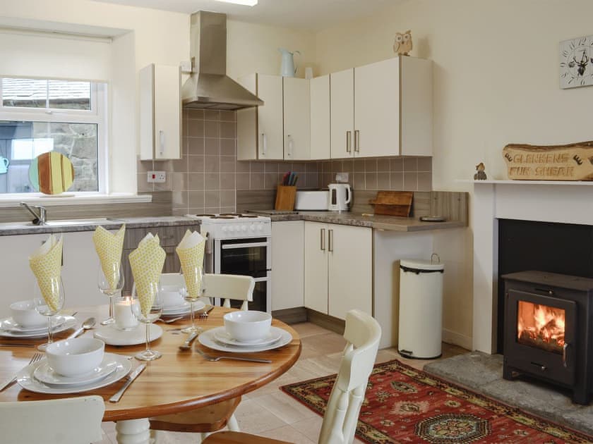 Delightful kitchen/ dining room with wood burner | Glenhowl Lodge, Dalry, near Castle Douglas