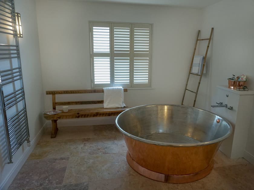 Luxurious bathroom with circular, copper bath | Garden House, Thimbleby, near Northallerton