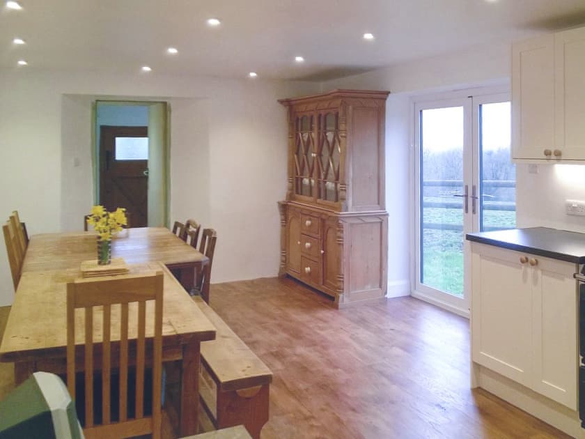 Large dining area with double doors to garden | Tutchenor Farmhouse, Patchacott, near Beaworthy