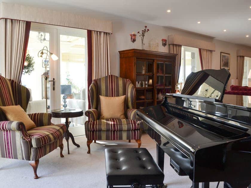Living room with baby grand piano  | Bodrydd - Bodrydd, Rhoshirwaun, near Pwllheli