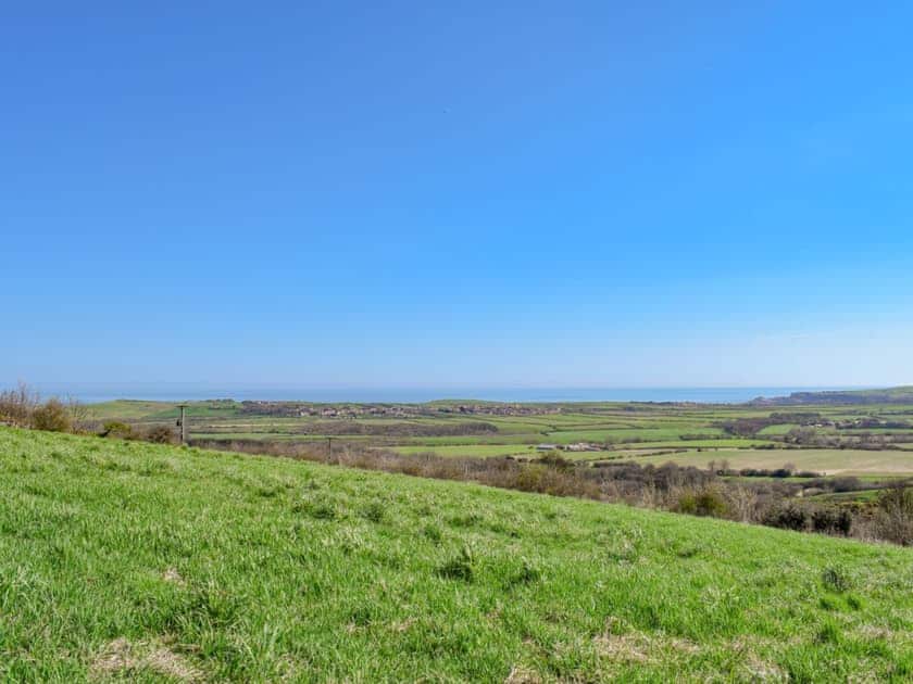 Stunning views from the bottom of the yard towards the coast, overlooking Hinderwell and Runswick Bay | Sycamore Cottage, Borrowby, near Staithes