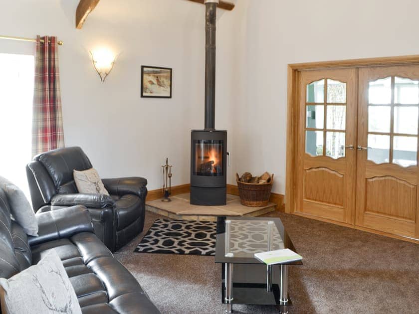 Welcoming living room with modern wood burner | Curlew Cottage, Near Bellingham