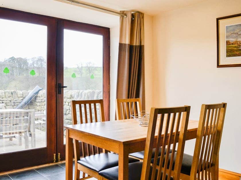 Dining area with patio doors to the seating area | Mill Barn, Hebden, near Grassington