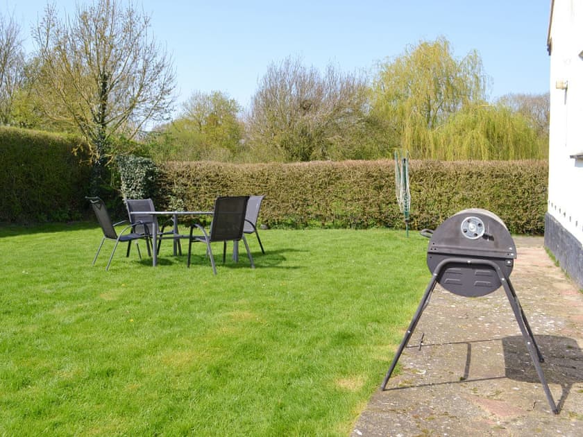 Lawned garden with outdoor furniture and BBQ | The Lodge - Scarning Dale Cottages, Scarning, near Dereham
