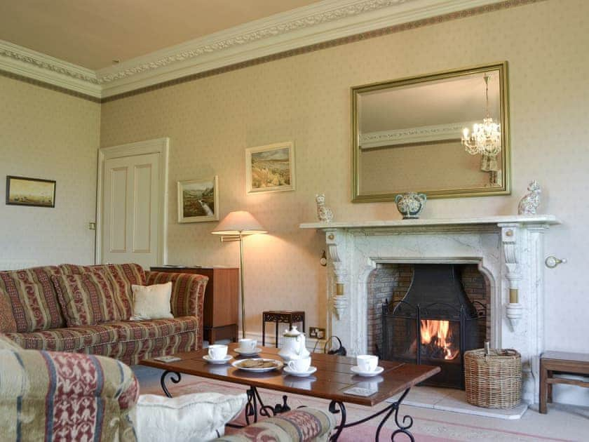 Comfortable living room with open fire | Tirril Lodge, Tirril, Ullswater