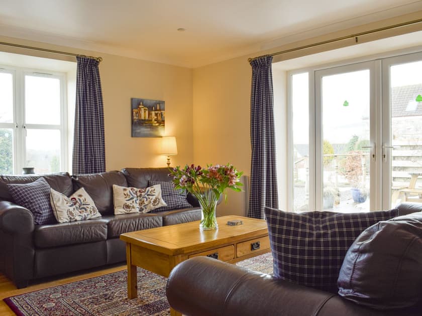 Welcoming living area with French door to decked patio | White Wisp, Kinross