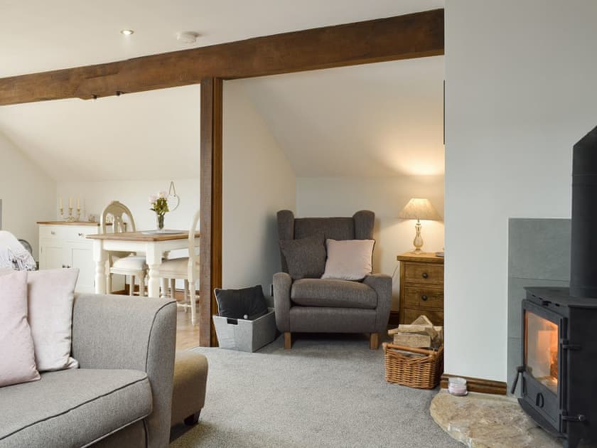 Cosy open-plan living area with wood burner | Fields Farm Apartment, Peak Forest, near Buxton