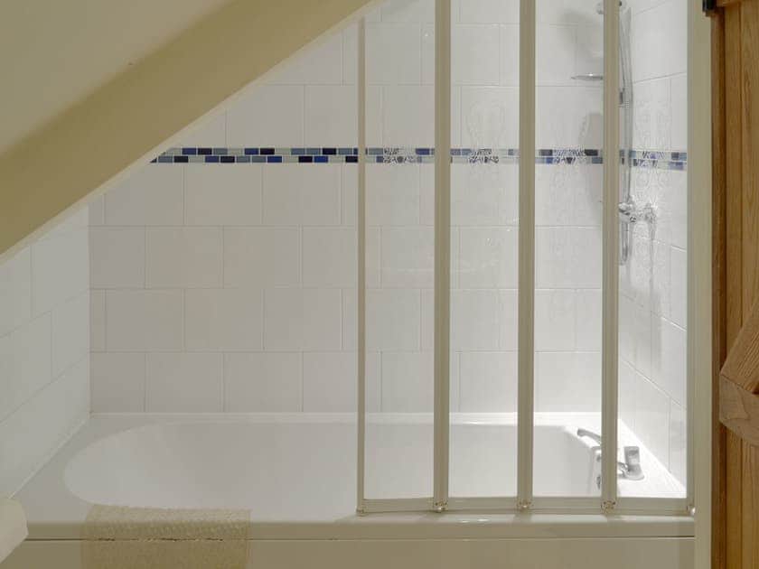 Bathroom with shower over bath | Clyst William Barn - Little Clyst William Farm Cottages, Plymtree, near Cullompton