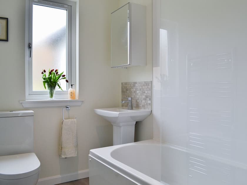 Bathroom with heated towel rail and shower over bath | Invernoe Cottage, Taynuilt, near Oban