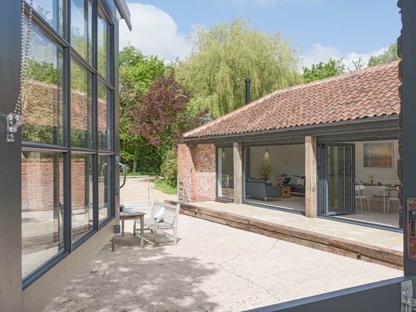 View from double bedroom to enclosed patio | The Cowshed, Reepham