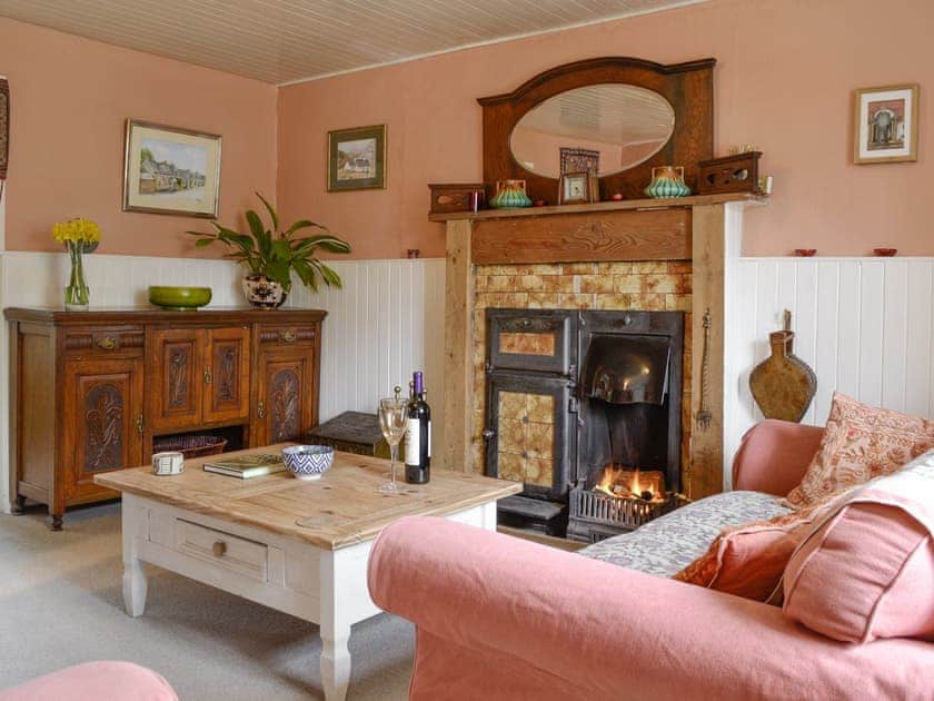 Welcoming living room with open fire | Larch Cottage, Kirkmichael, near Pitlochry