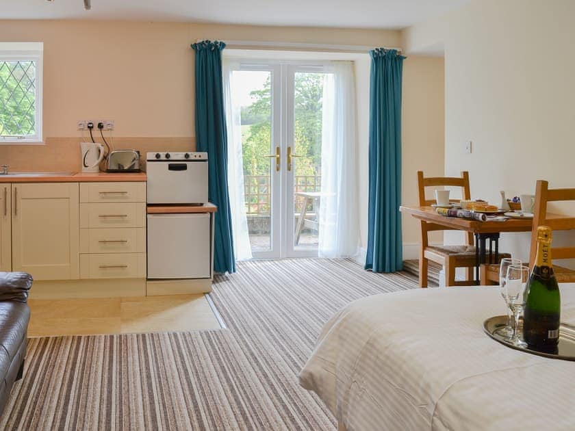 Delightful open plan living area with French doors to the garden | Lee Studio - Trimstone Manor Cottages, Trimstone, near Woolacombe