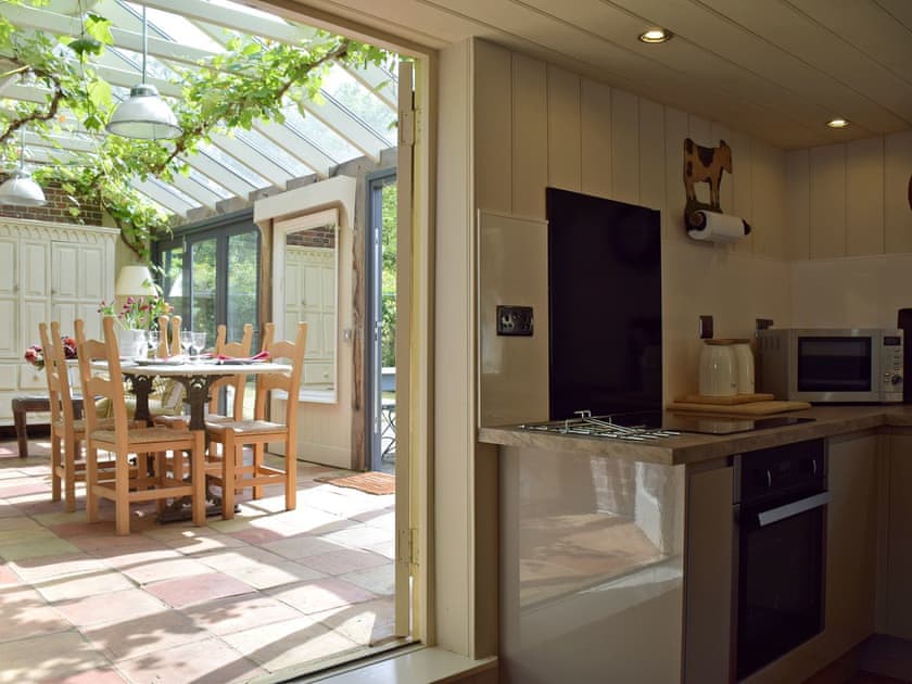 Kitchen through to light and airy conservatory | Swallows Nest, Ilketshall St. Margaret, near Bungay