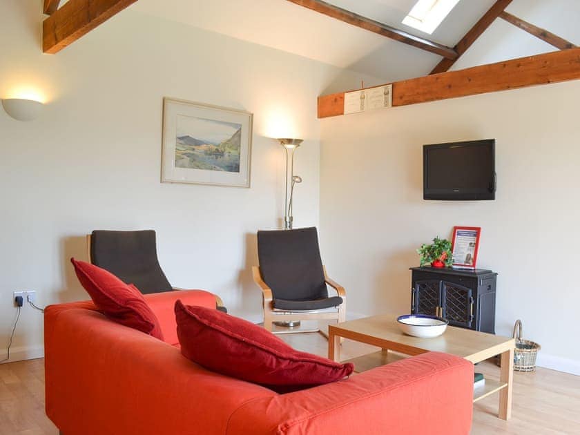 High-ceilinged open plan living area with exposed wooden beams | Stables Cottage - Mackinder Farms, Brayton, Selby