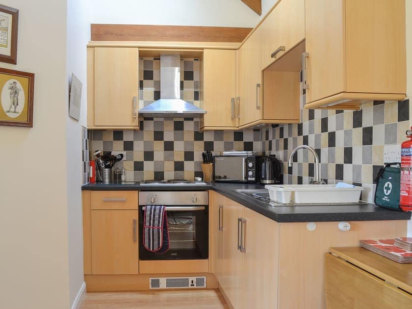 Tiled kitchen with a range of units and appliances | Stables Cottage - Mackinder Farms, Brayton, Selby