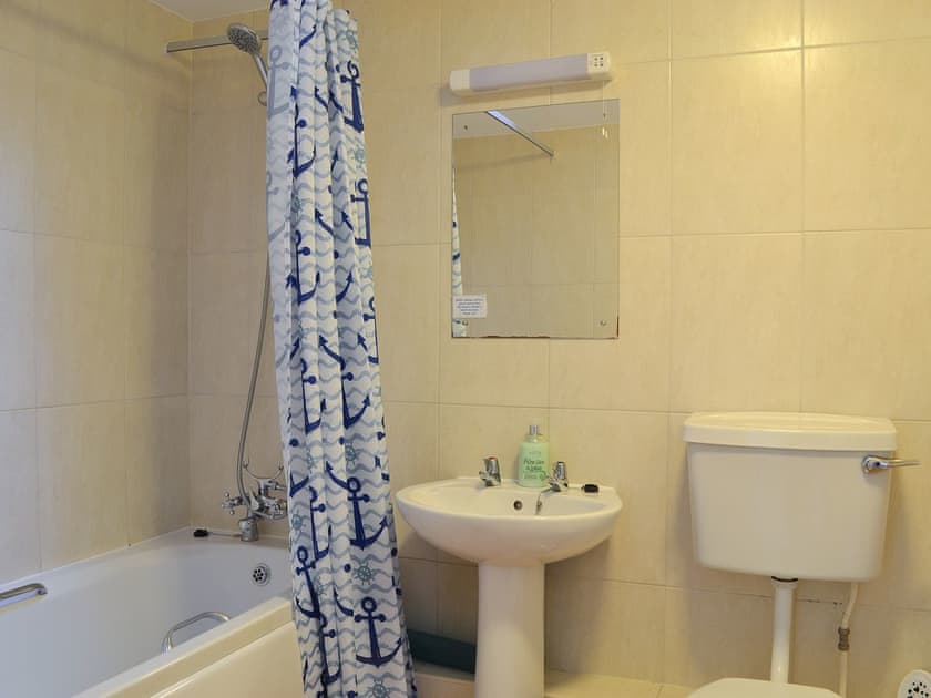 Delightful bathroom with shower over the bath | Stables Cottage - Mackinder Farms, Brayton, Selby