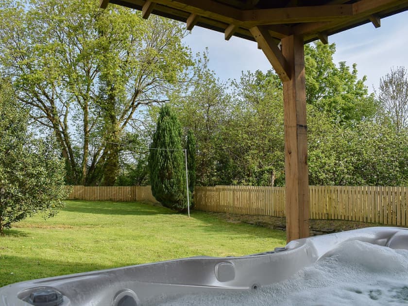 Look out over the garden from the relaxing hot tub | Maes yr Onnen, Abercych, near Cardigan