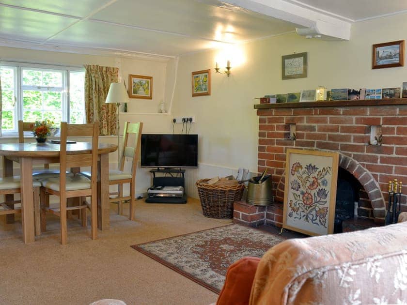 Light and sunny living/dining room with open fire | October Cottage, Aughton, near Marlborough