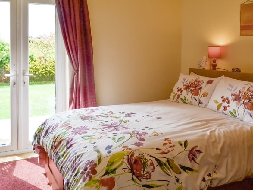 Relaxing double bedroom with French doors to garden | 1¾ Denwick View, Alnwick