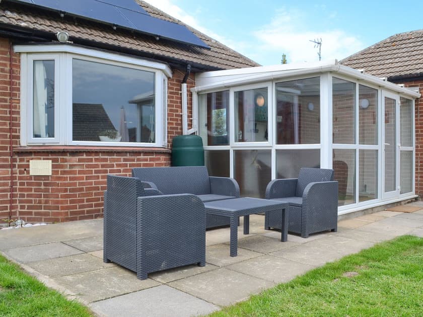 Paved patio area with furniture | Sea La Vie, Mundesley, near North Walsham