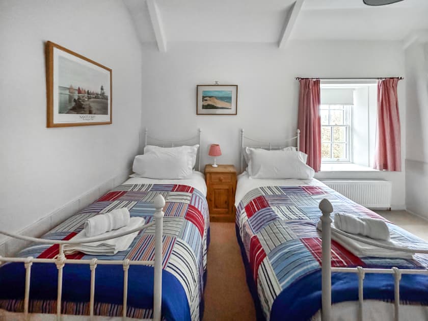 erful twin bedroom with traditional iron frame beds and cosy bedding | Fallodon Burnhouses, near Beadnell