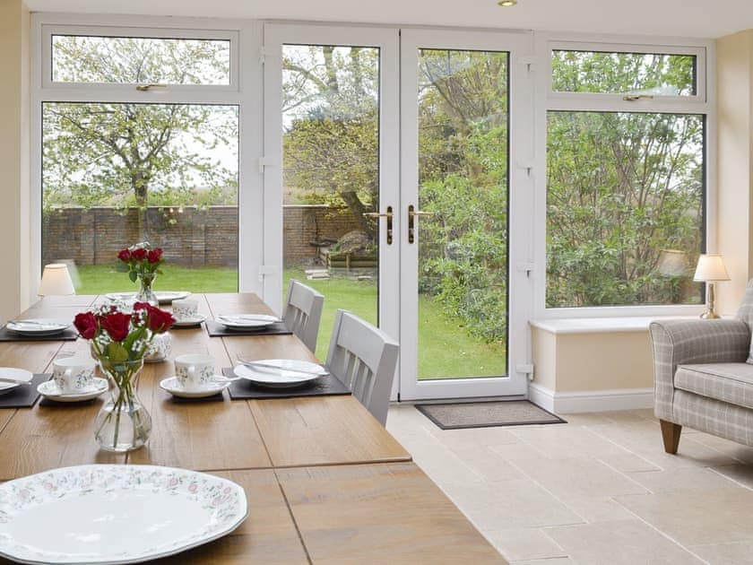Spacious and contemporary dining room with French doors to garden | The Gatehouse - Eldin Hall Cottages, Scarborough