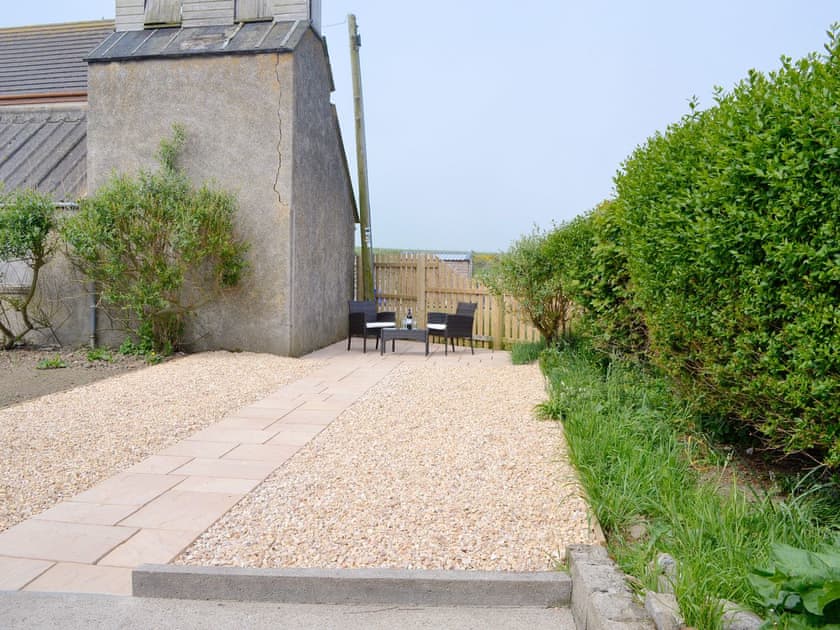 Paved and gravelled patio leading to an additional outdoor seating area | Westcliff, Whitehills, near Banff