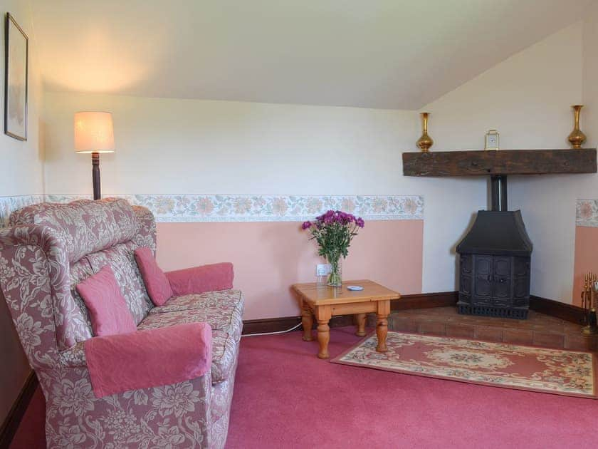 Cosy and comfortable living room with wood burner | The Cider Mill Cottage, Orleton, near Ludlow