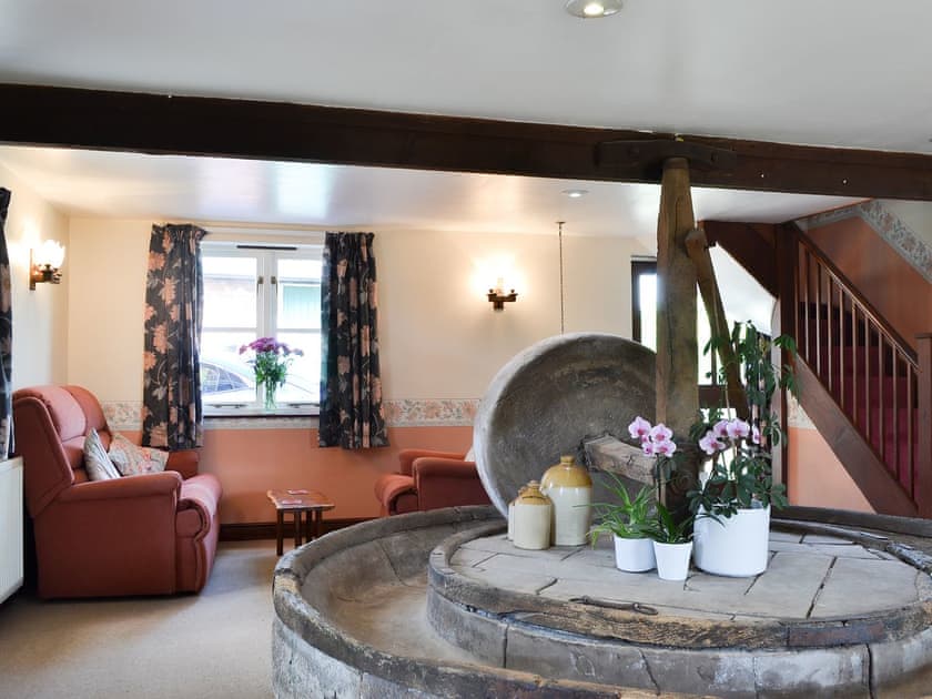 Dining room with original  apple crusher | The Cider Mill Cottage, Orleton, near Ludlow
