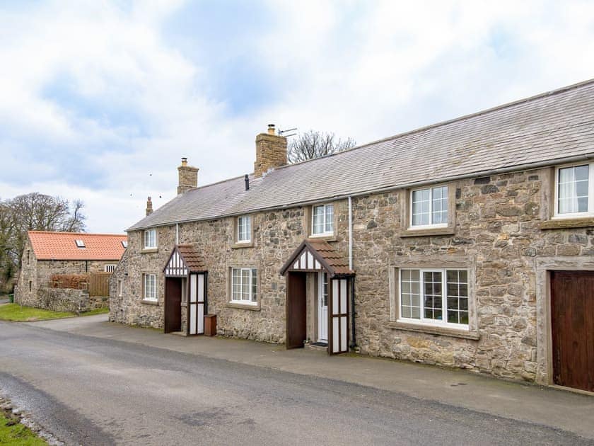 Attractive end-terrace stone-built holiday home pictured centrally | Seascape - Proctors Stead Cottages, Dunstan, near Craster