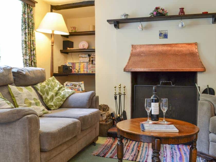 Cosy living room with an open fire in living room | Yew Tree Cottage, Passfield Common, near Liphook