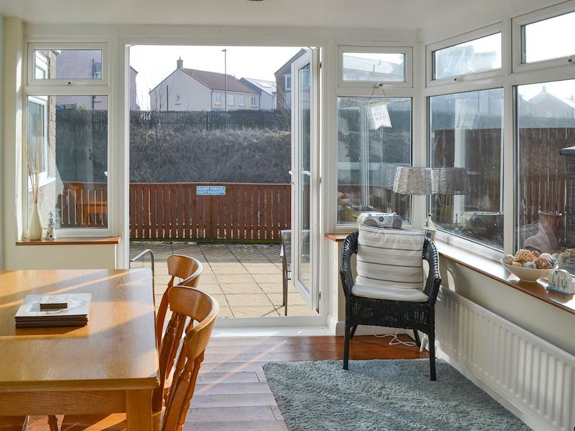 Dining area in the sun room | Longstone Bungalow, Beadnell