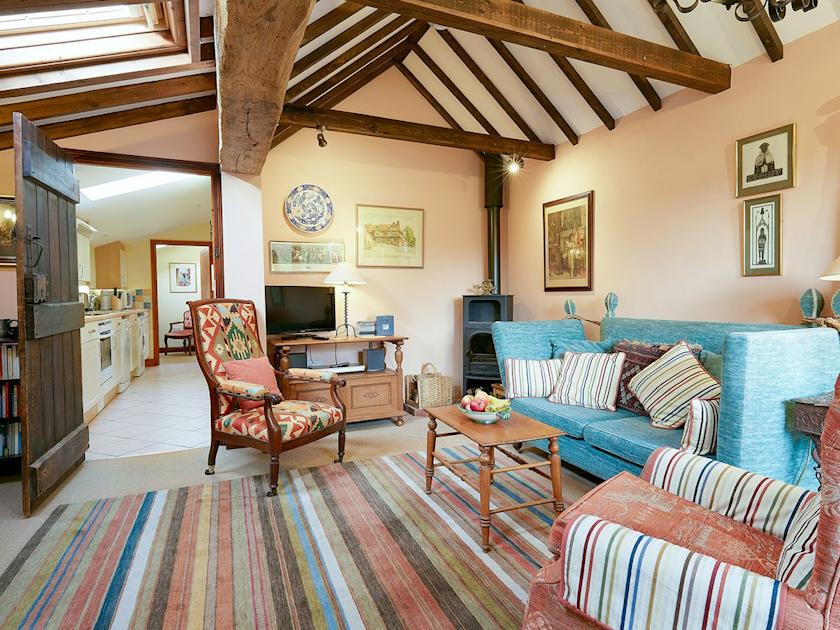 Living room with wood burner and beamed ceiling | Pippins, Great Hautbois, near Coltishall